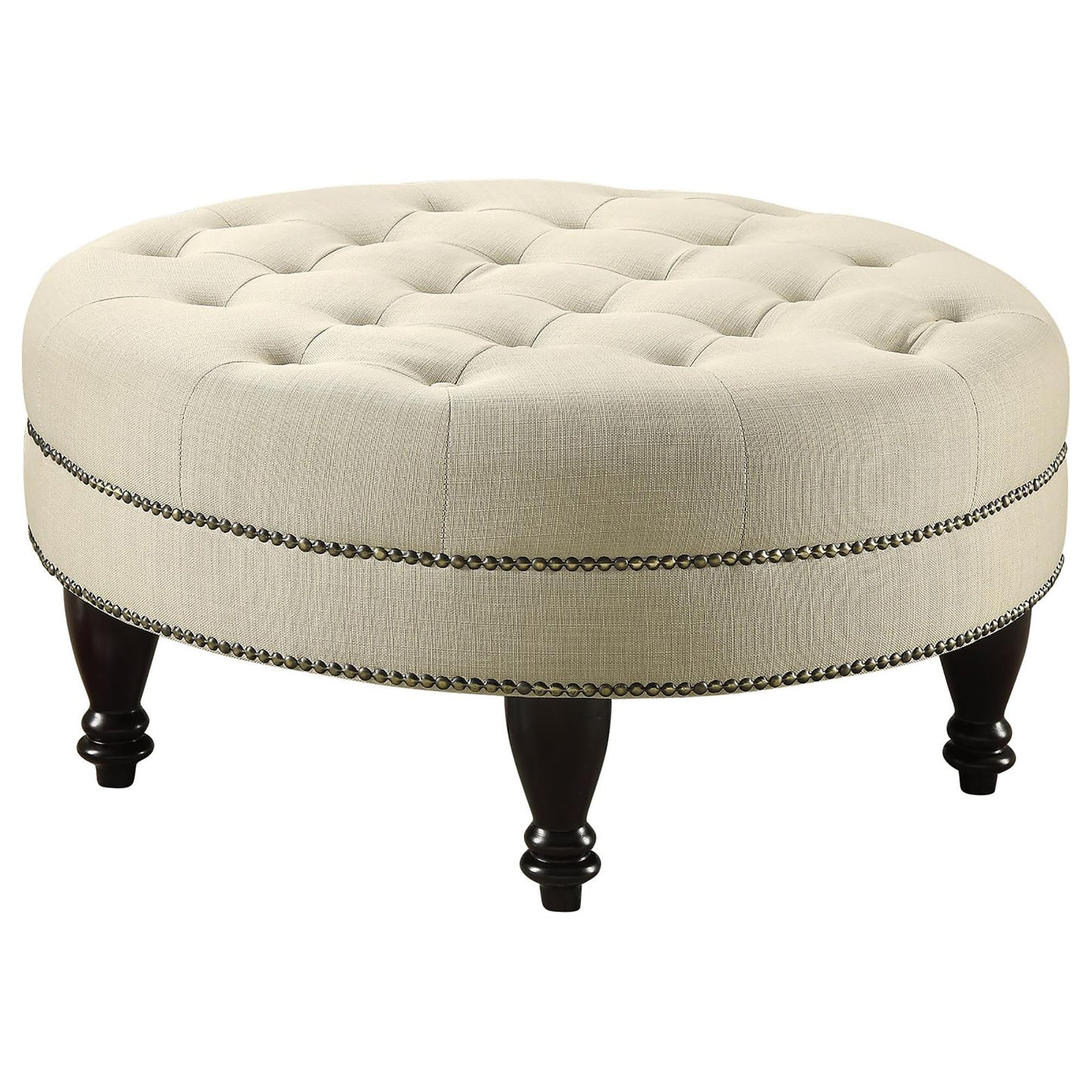 Cream tufted round ottoman with dark wooden legs and decorative nailhead trim accent
