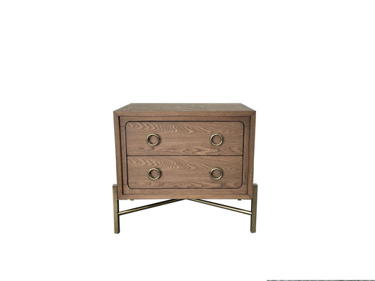 Wooden nightstand with two drawers and gold ring pulls on brass legs