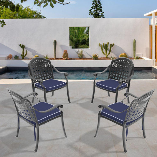 Dark grey cast aluminum patio chairs with navy cushions and white piping