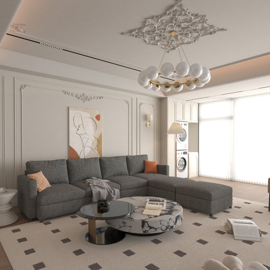 Gray fabric sectional sofa with orange and striped accent pillows in a modern living room