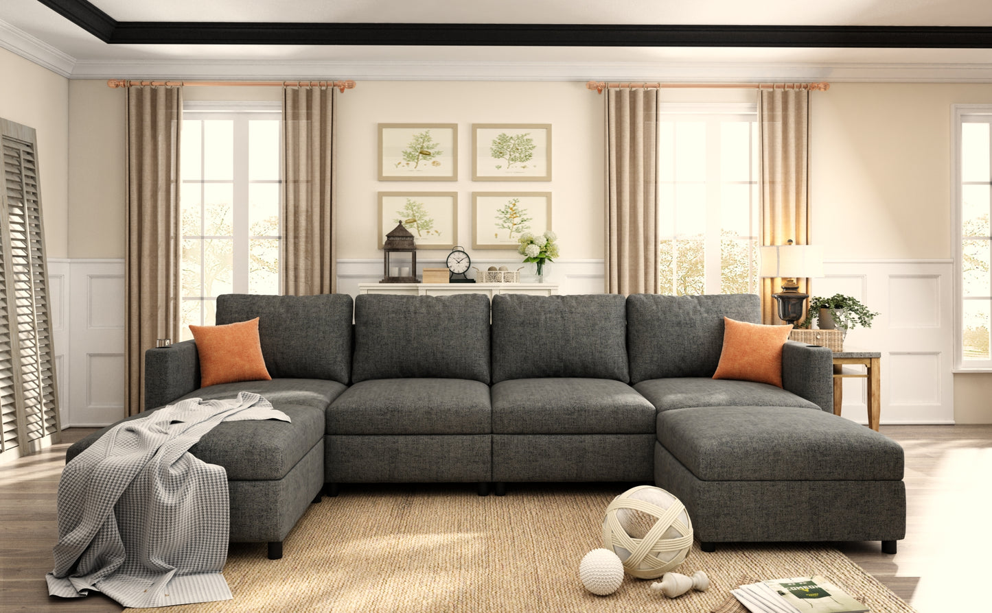 Dark gray sectional sofa with chaise lounge two orange accent pillows and woven throw blanket on a beige rug