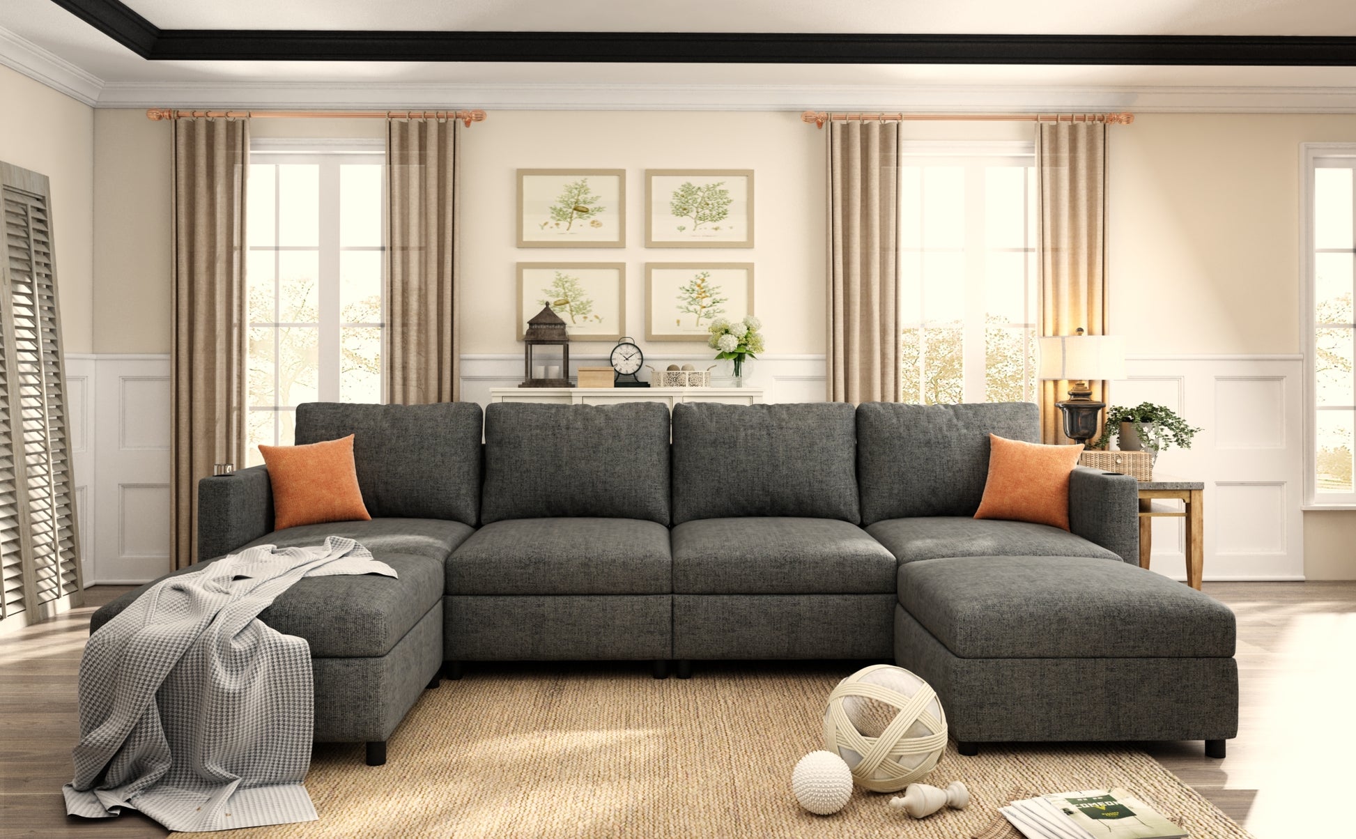 Dark gray sectional sofa with chaise lounge two orange accent pillows and woven throw blanket on a beige rug