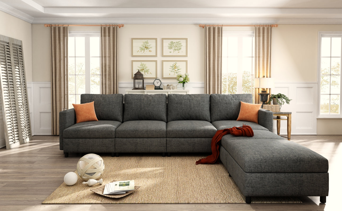 Dark grey sectional sofa with chaise and orange throw pillows