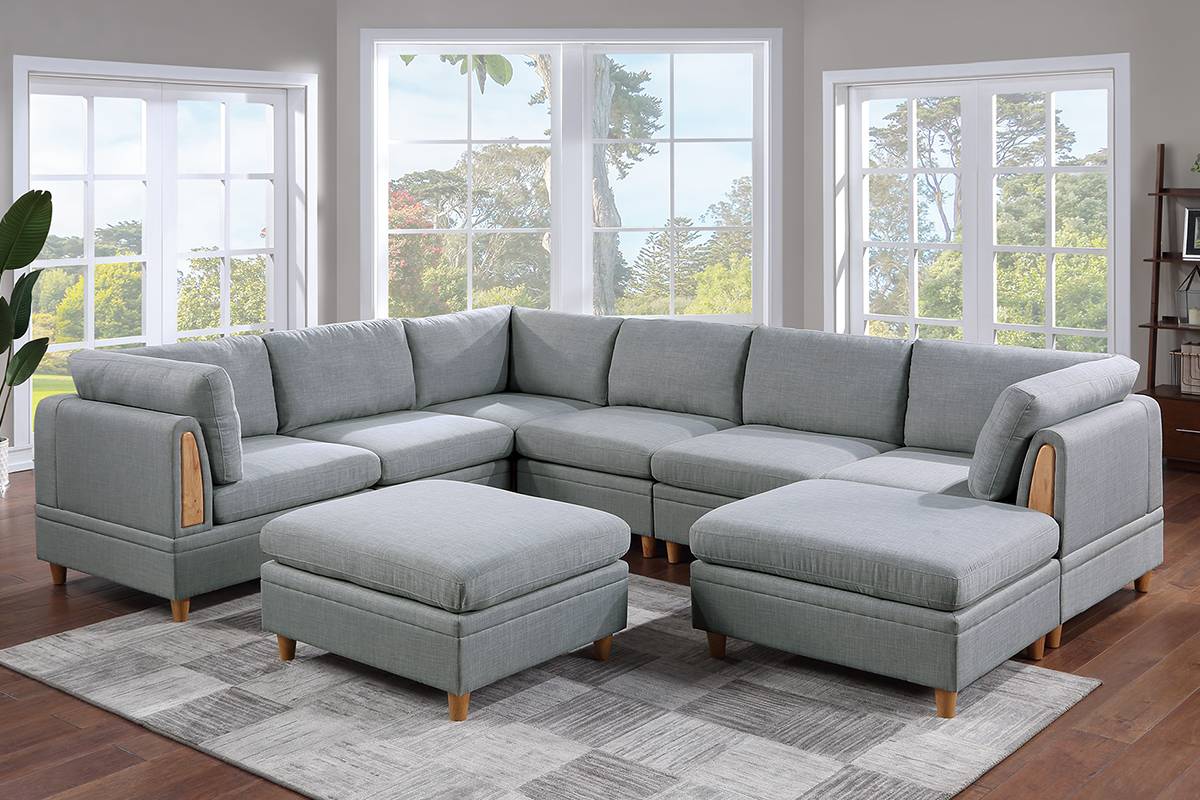 Light gray fabric sectional sofa with wooden accents and storage ottomans