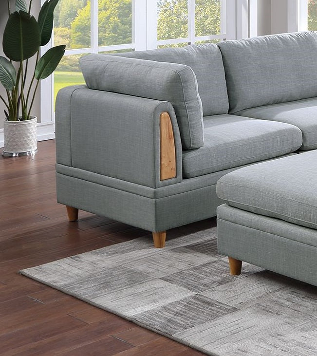 Light gray sectional sofa with wooden arm detail and matching ottoman