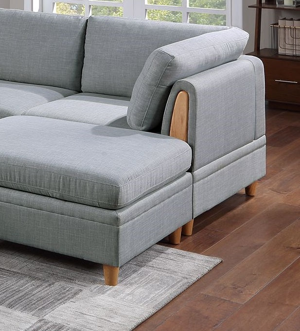 Light grey linen sectional sofa with wooden accents on armrest and natural wood legs