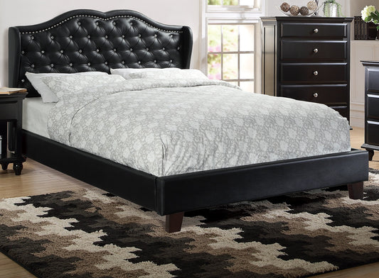Black tufted faux leather wingback bed with crystal accents and patterned bedding