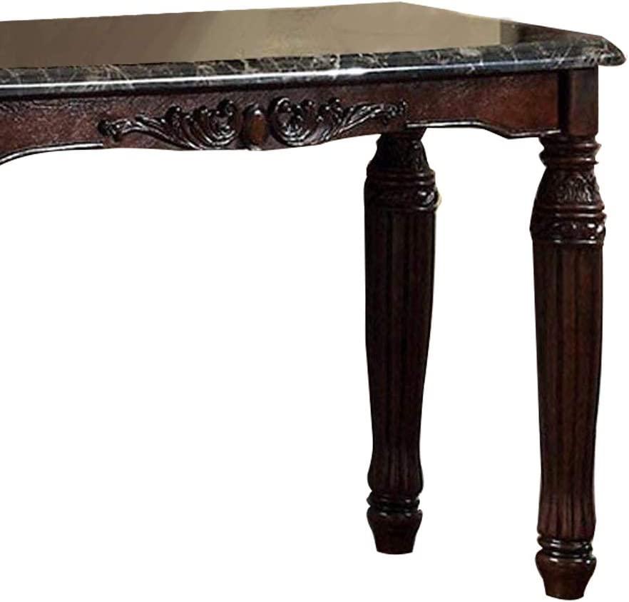 Dark wood ornate dining table with carved legs and marble inlay top