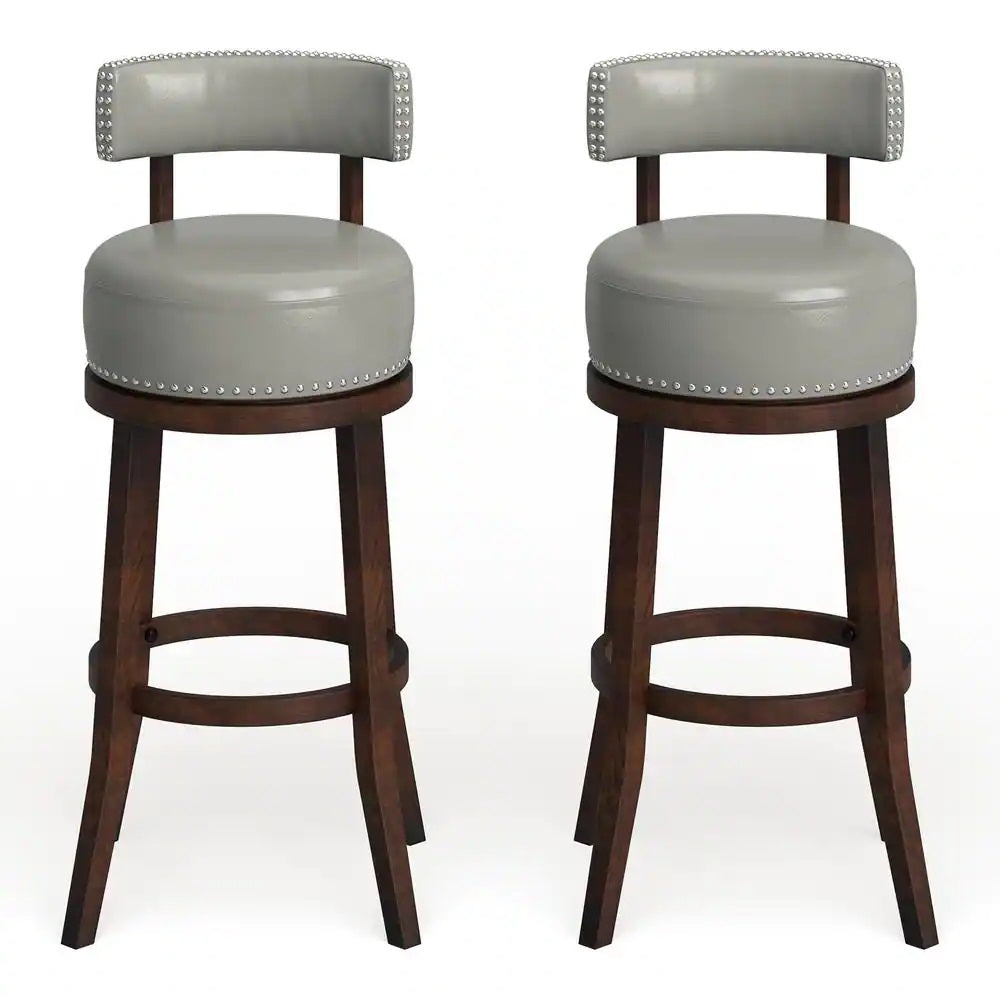 Two grey faux leather swivel bar stools with nailhead trim and wooden legs
