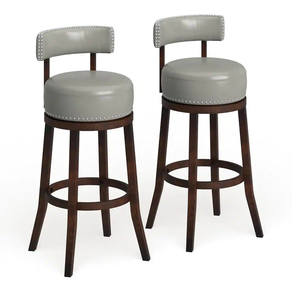 Pair of grey leather swivel bar stools with nailhead trim and dark wood legs