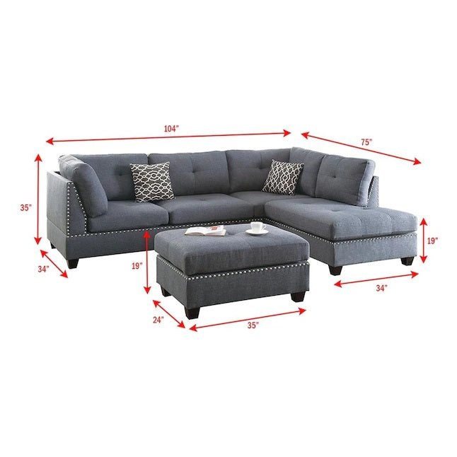 Dark gray upholstered sectional sofa with silver nailhead trim and accent pillows