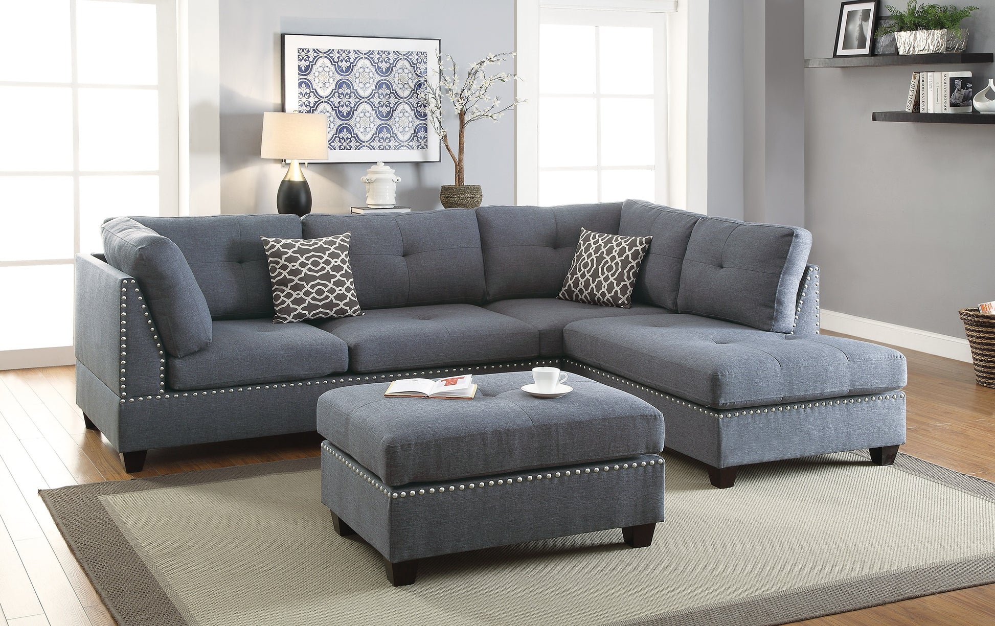 Tufted gray fabric sectional sofa with nailhead trim and matching ottoman