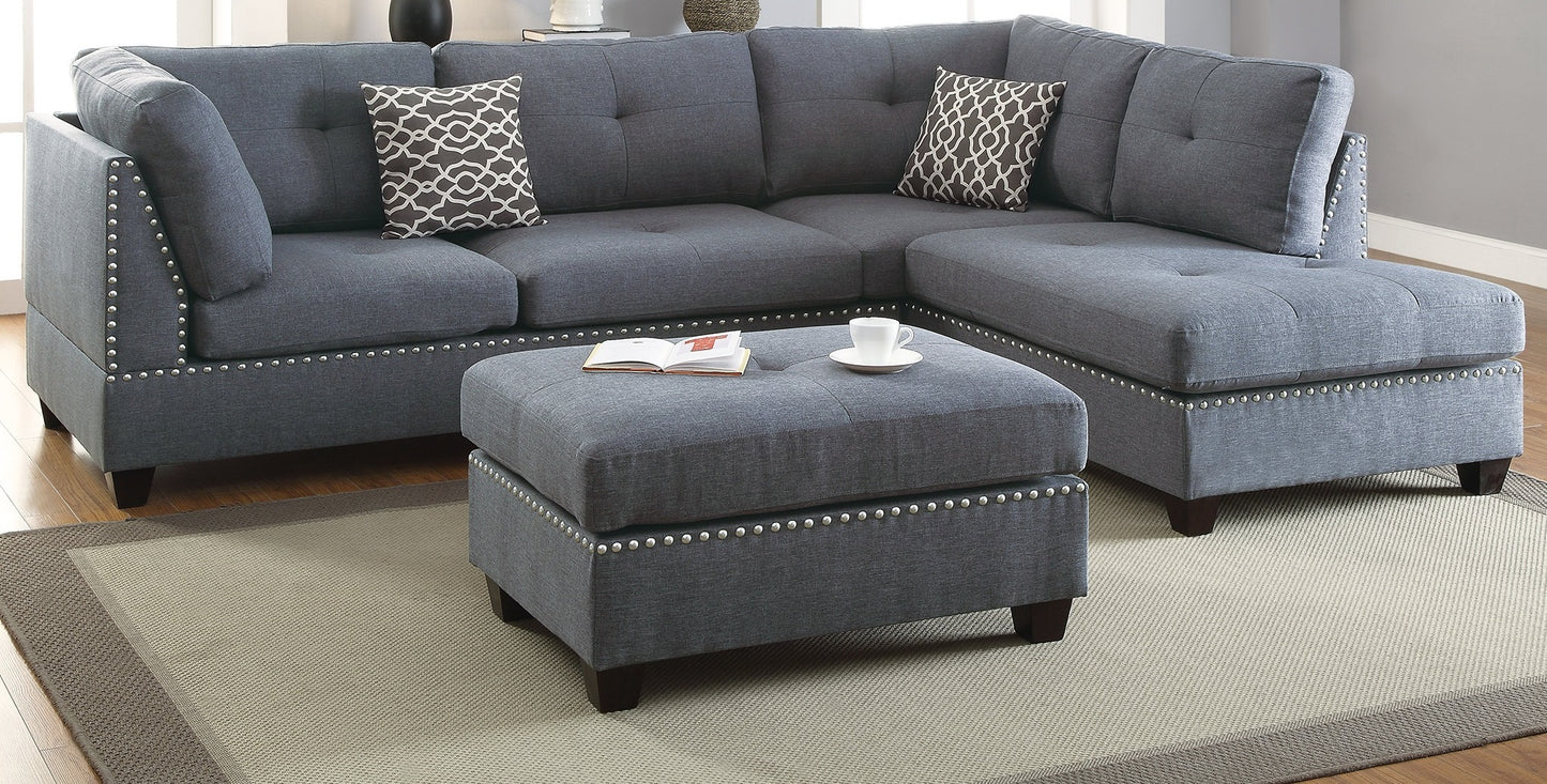 Tufted grey fabric sectional sofa with silver nailhead trim and decorative throw pillows