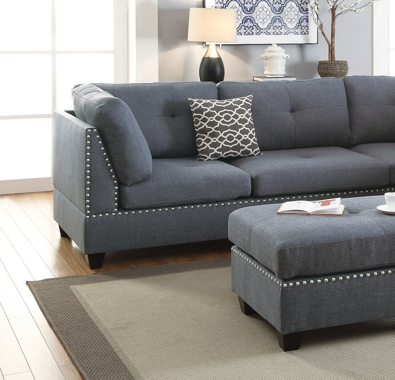 Tufted charcoal grey sectional sofa with silver nailhead trim perfect for a modern living room