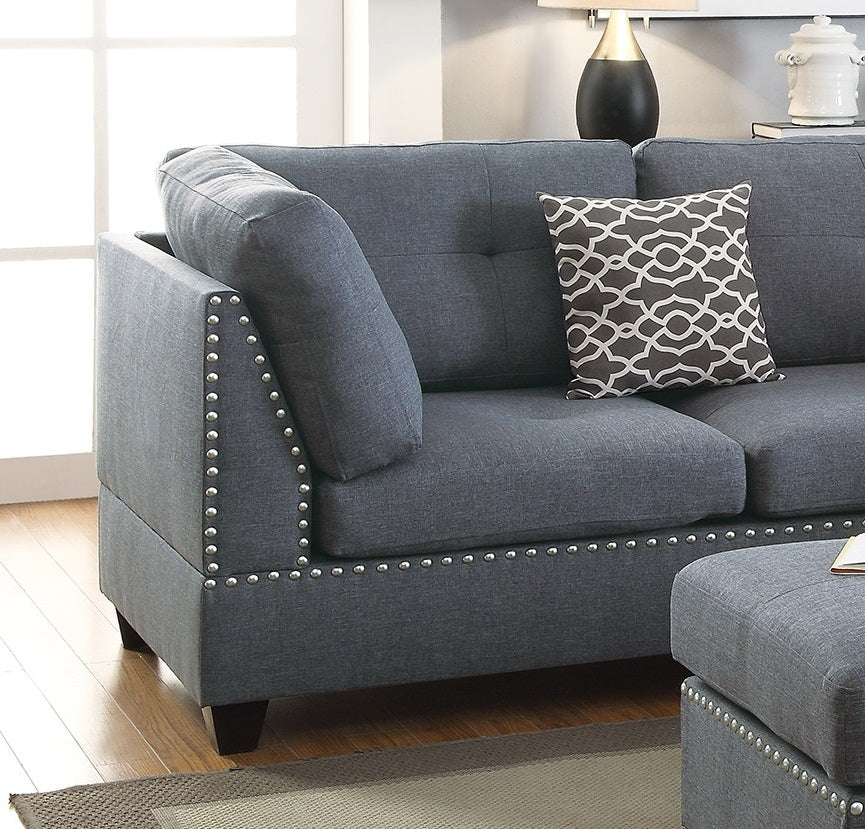 Dark gray upholstered sofa with decorative nailhead trim and accent pillow
