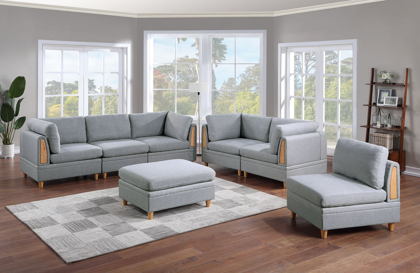 Grey fabric sectional sofa with wooden arm accents and matching ottoman
