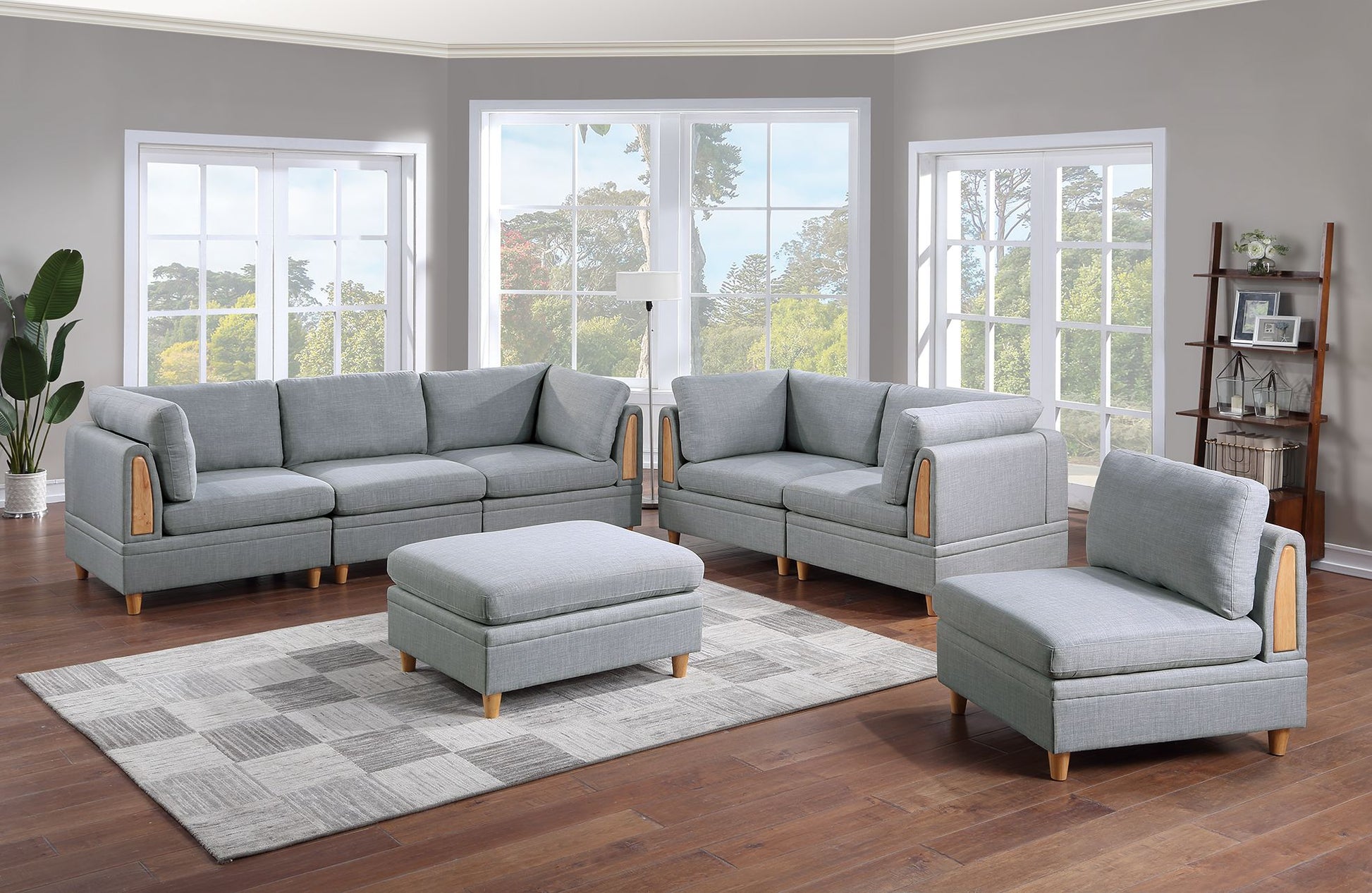 Grey fabric sectional sofa with wooden arm accents and matching ottoman
