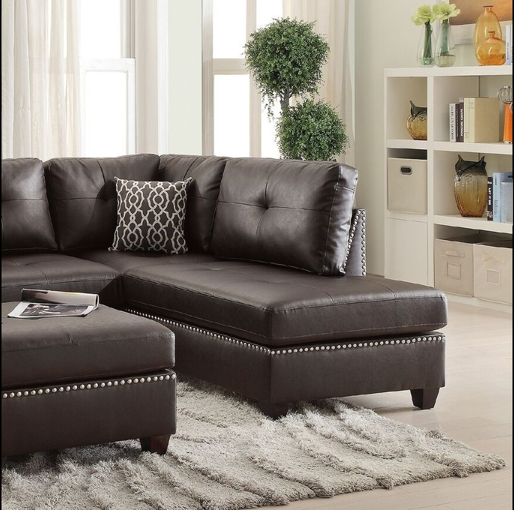 Dark brown leather sectional sofa with tufted cushions and studded trim featuring a chaise lounge