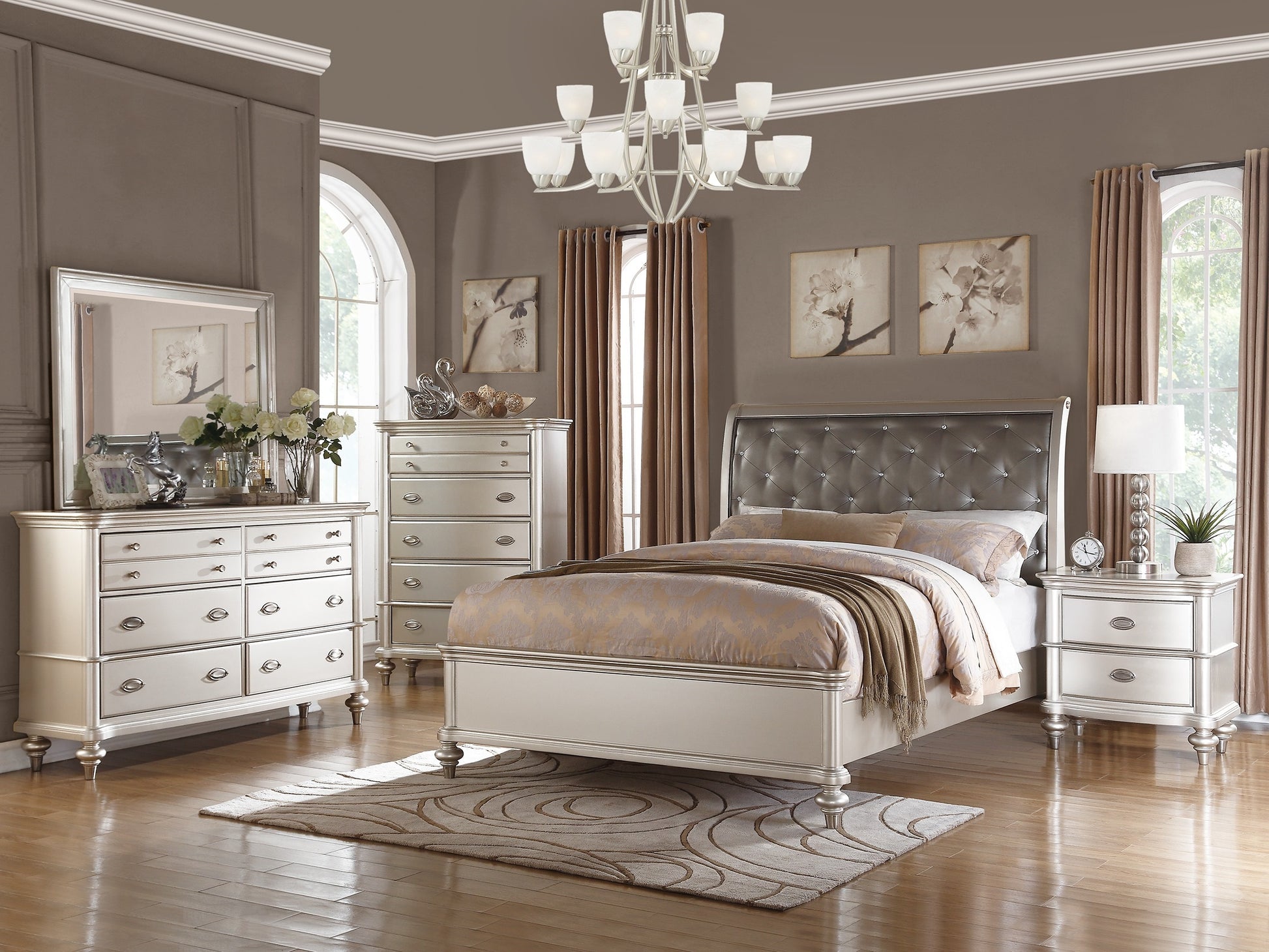 Silver upholstered tufted headboard queen bed with ornate detailing and decorative pillows for bedroom elegance