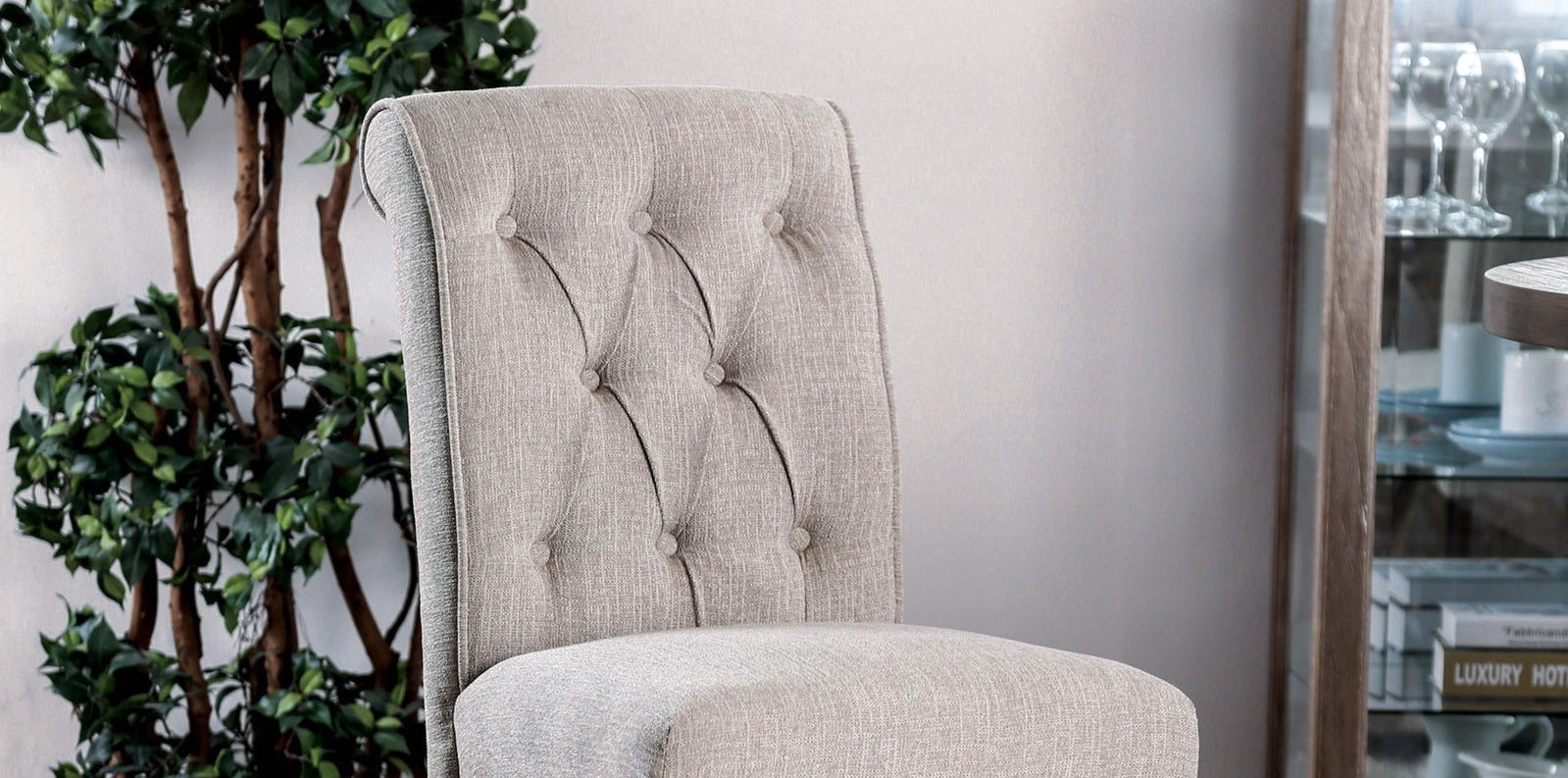 Tufted grey fabric dining chair with buttonback detail and rolled top