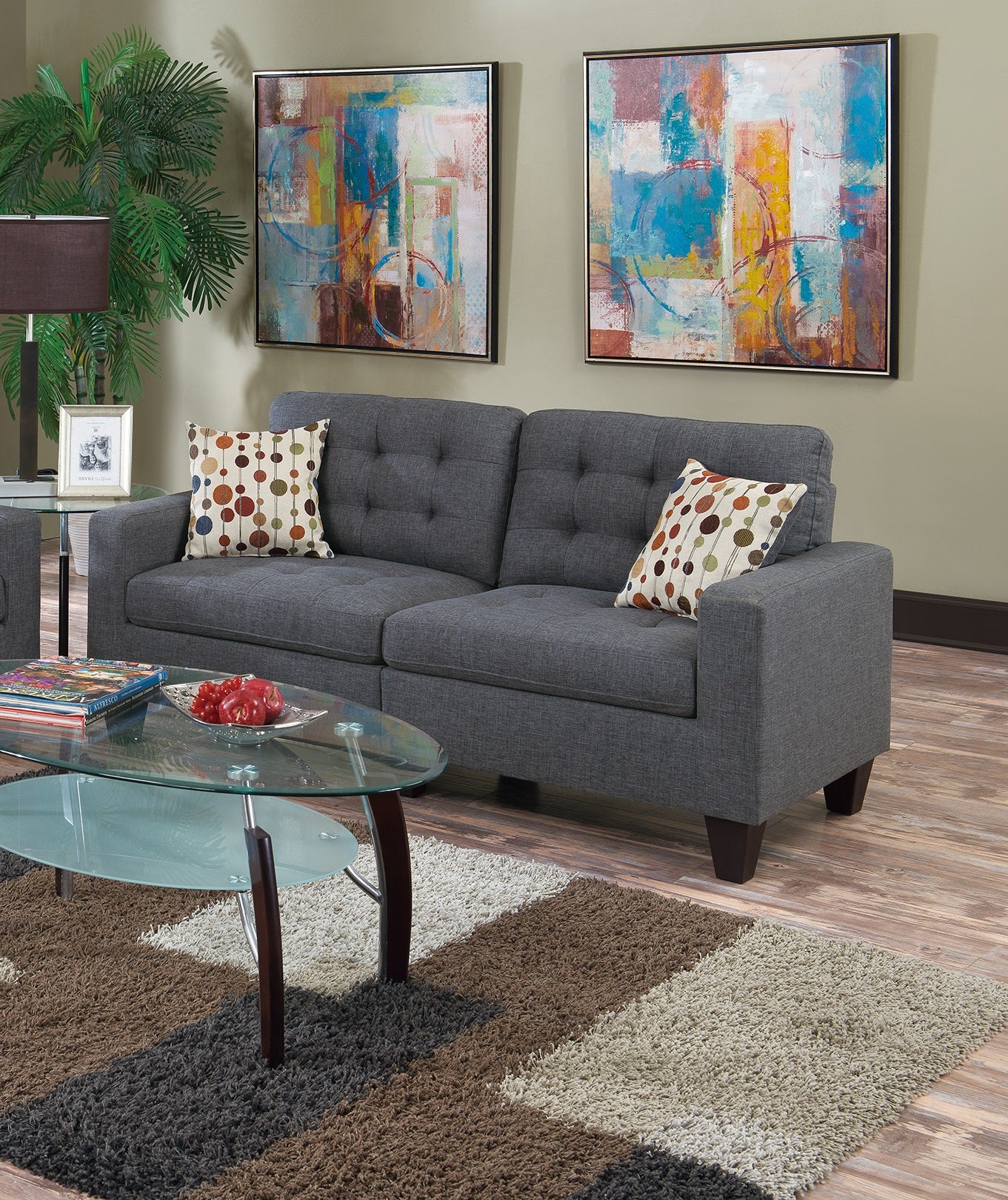 Dark gray tufted sofa with colorful dot accent pillow modern living room style