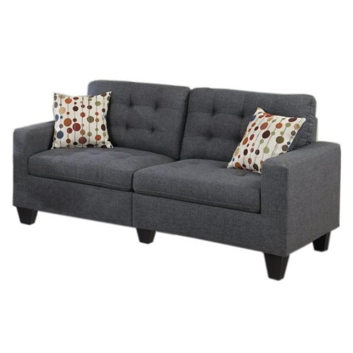 Charcoal grey fabric sofa with tufted back cushions and patterned throw pillows