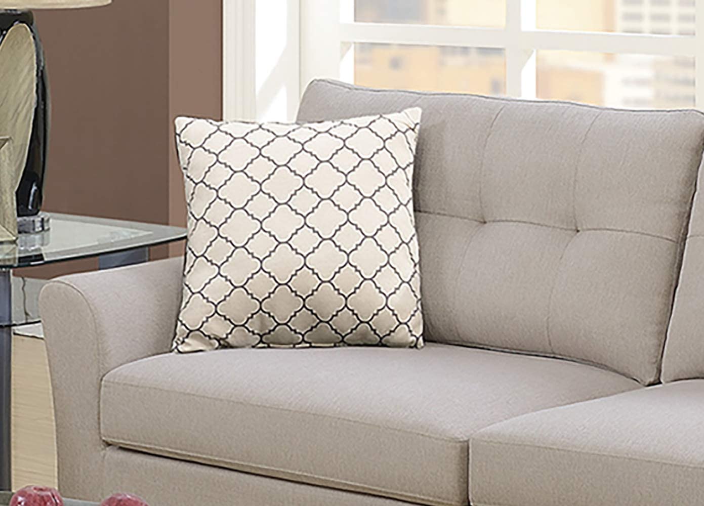 Decorative throw pillow with a cream background and a subtle geometric quatrefoil pattern in charcoal grey