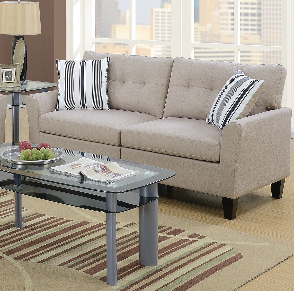 Taupe fabric sofa with tufted cushions and striped accent pillows