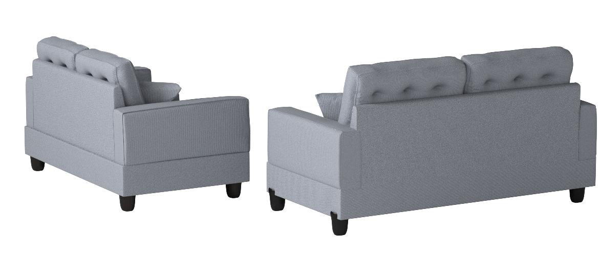 Gray fabric sofa with tufted back cushions and black legs