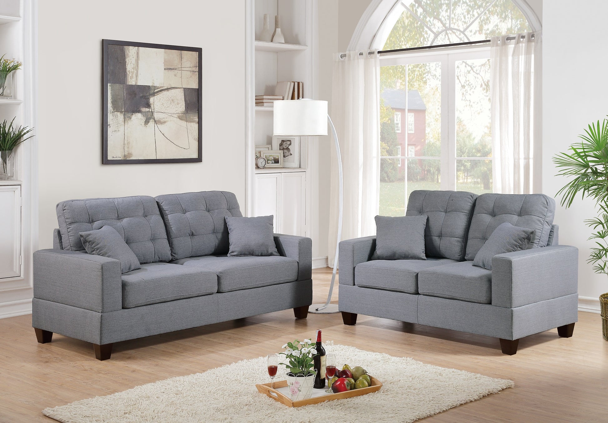 Tufted grey fabric loveseat with plush cushions a modern addition to living spaces