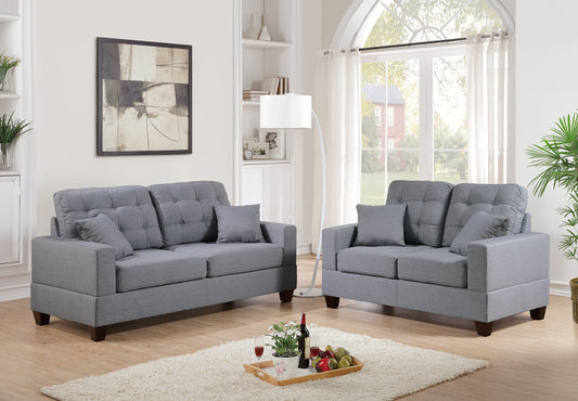 Tufted grey fabric loveseat with plush cushions a modern addition to living spaces