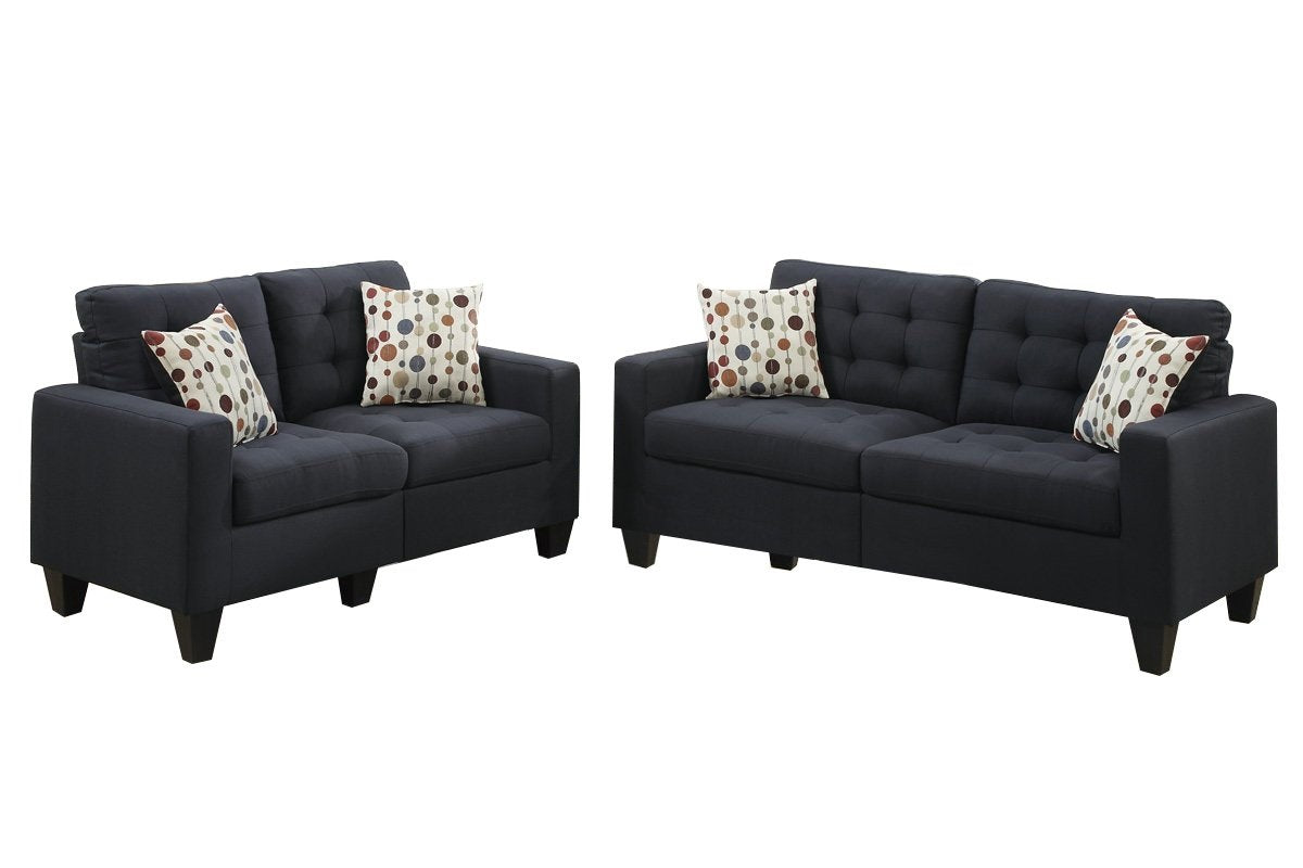 Dark grey fabric loveseat with tufted cushions and decorative pillows
