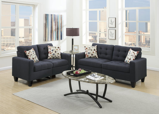 Tufted dark navy fabric sofa with patterned throw pillows for living room comfort