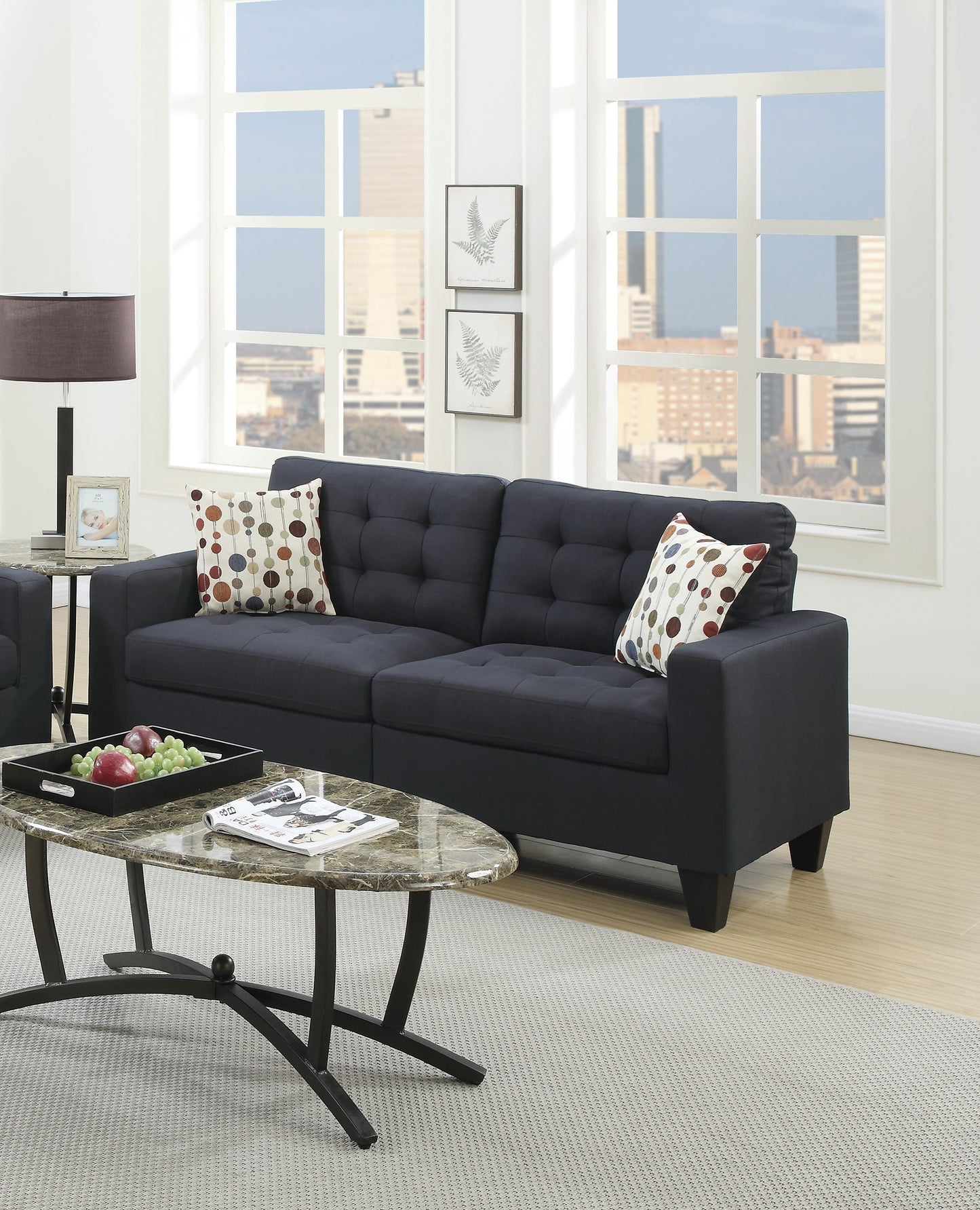 Dark navy upholstered sofa with tufted back and accent pillows in a modern living room
