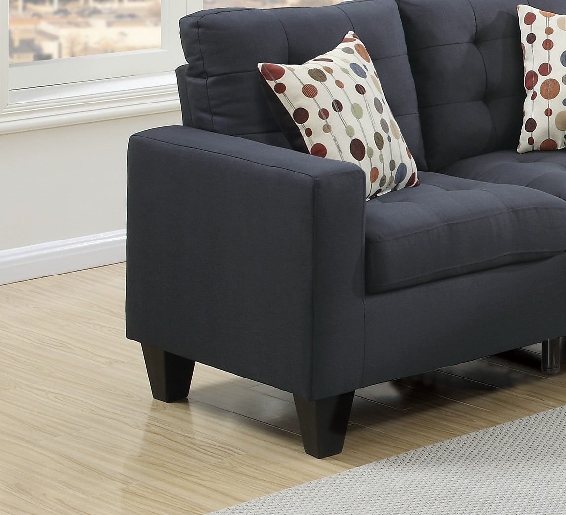 Dark grey tufted sectional sofa with decorative dot pillows