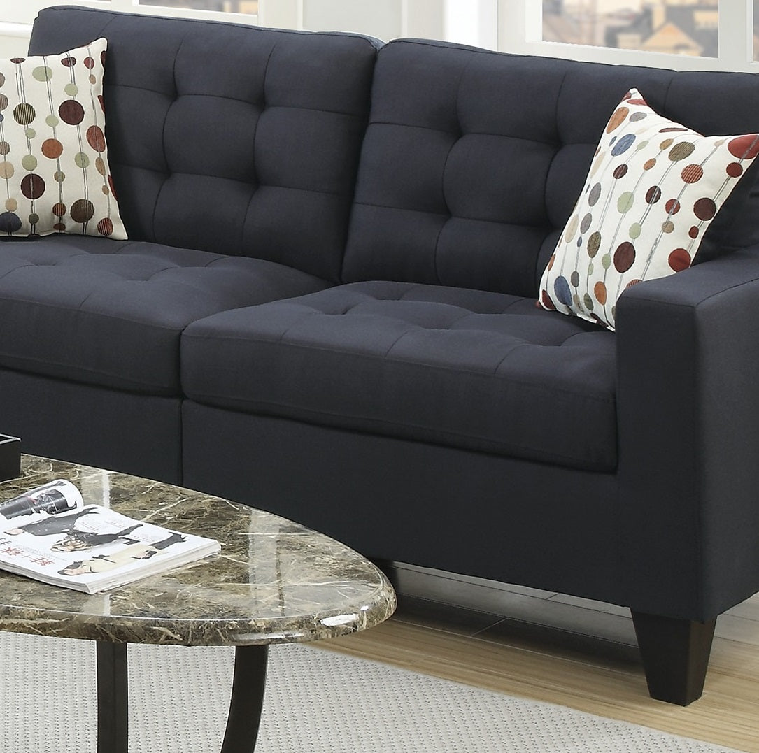 Tufted navy blue fabric sofa with decorative throw pillows