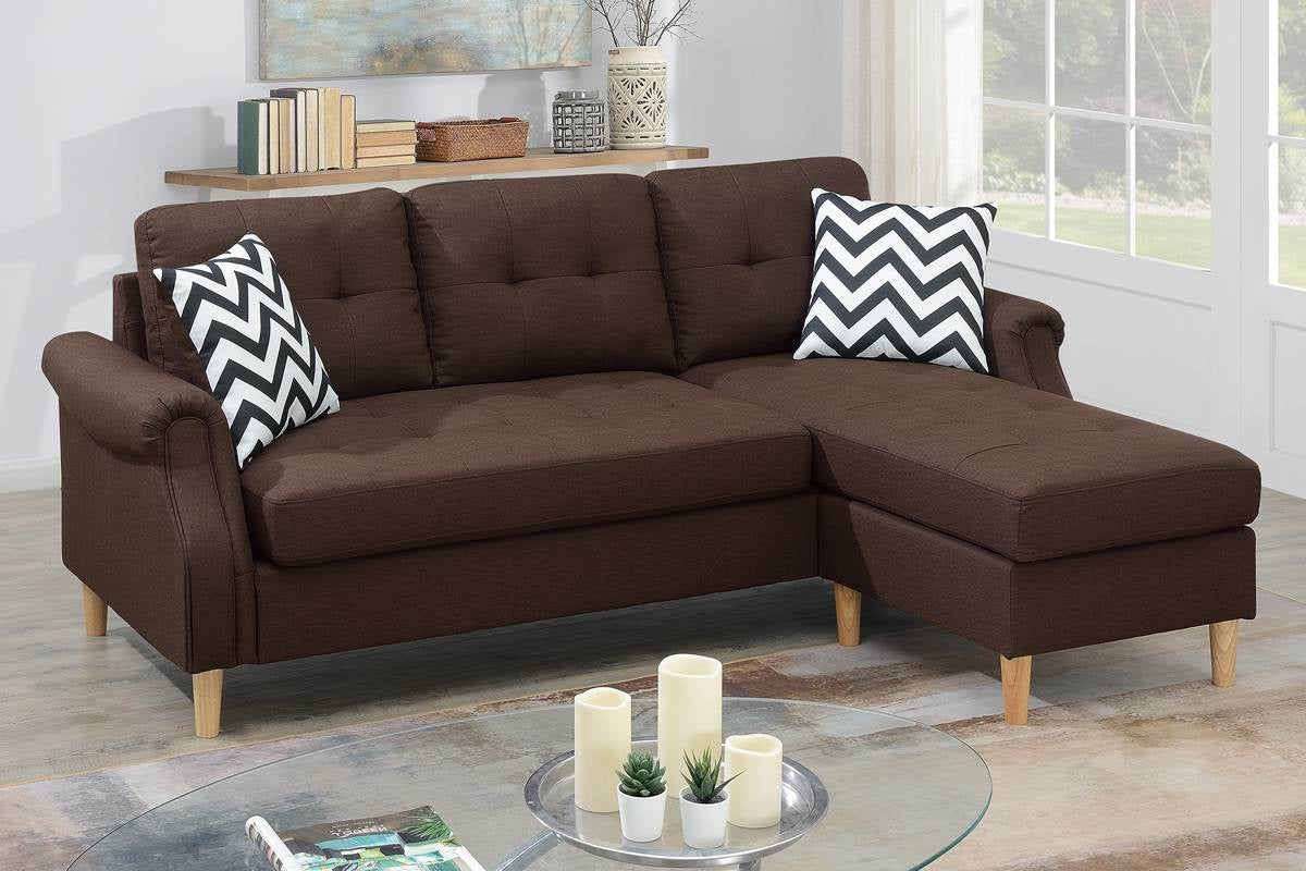 Tufted brown fabric sectional sofa with black and white chevron accent pillows