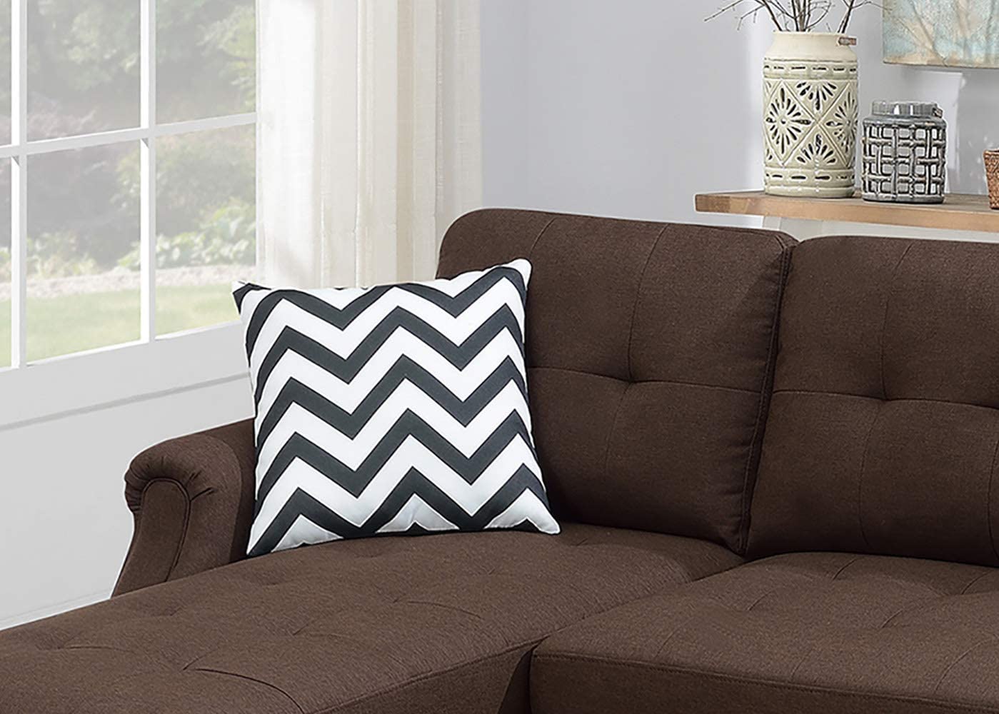 Black and white chevron throw pillow on a brown sofa adding modern accent style