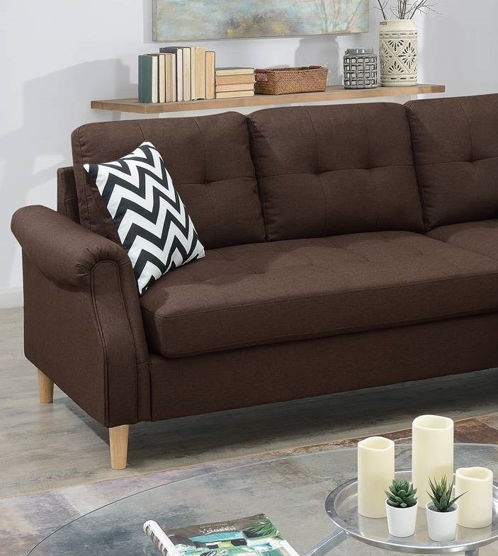 Tufted brown fabric sectional sofa with a modern chevron pillow on armrest