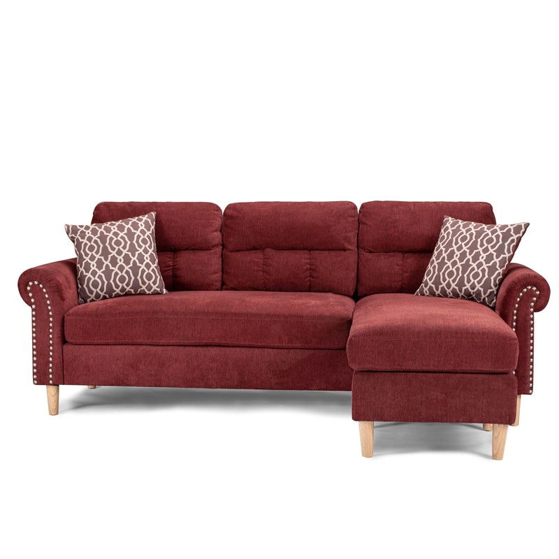 Deep red fabric sectional sofa with tufted cushions and decorative nailhead trim