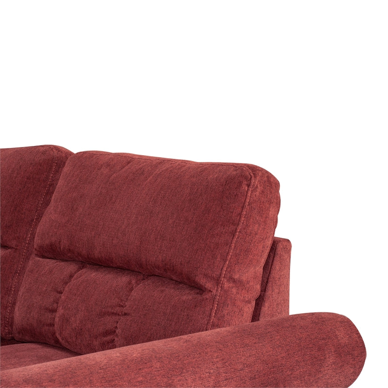 Close up of plush red fabric sofa headrest with channel tufting and quilted details