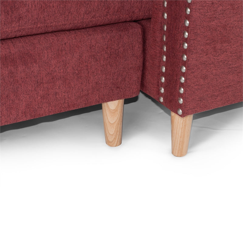 Closeup of red fabric sofa legs with nailhead trim detailing