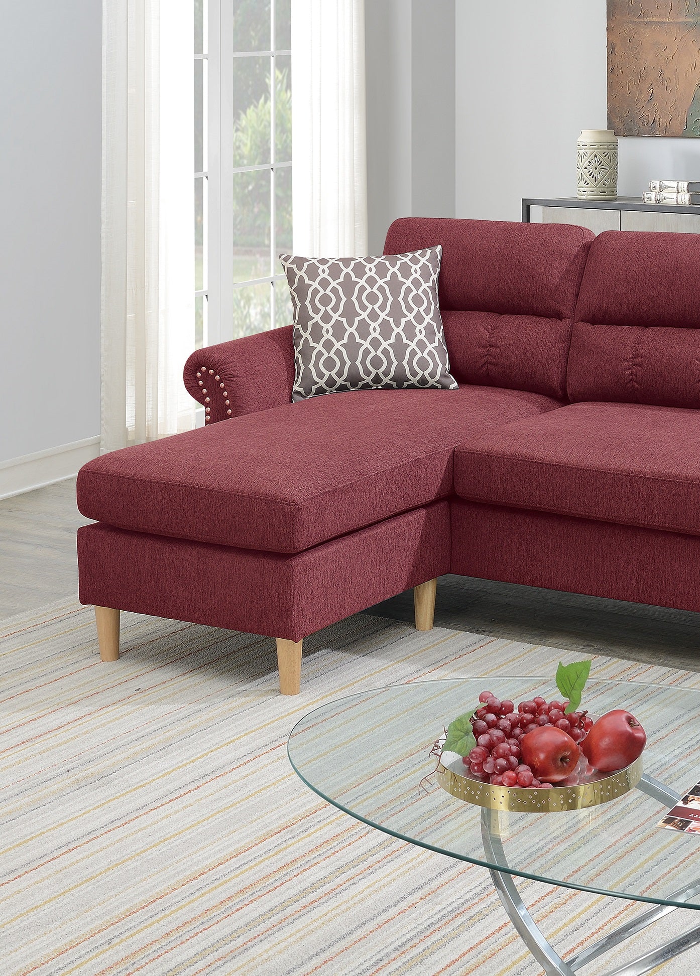 Burgundy upholstered sectional sofa with chaise and decorative nailhead trim