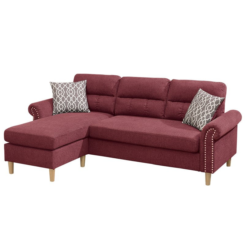 Deep red fabric sectional sofa with tufted back cushions and decorative nailhead trim