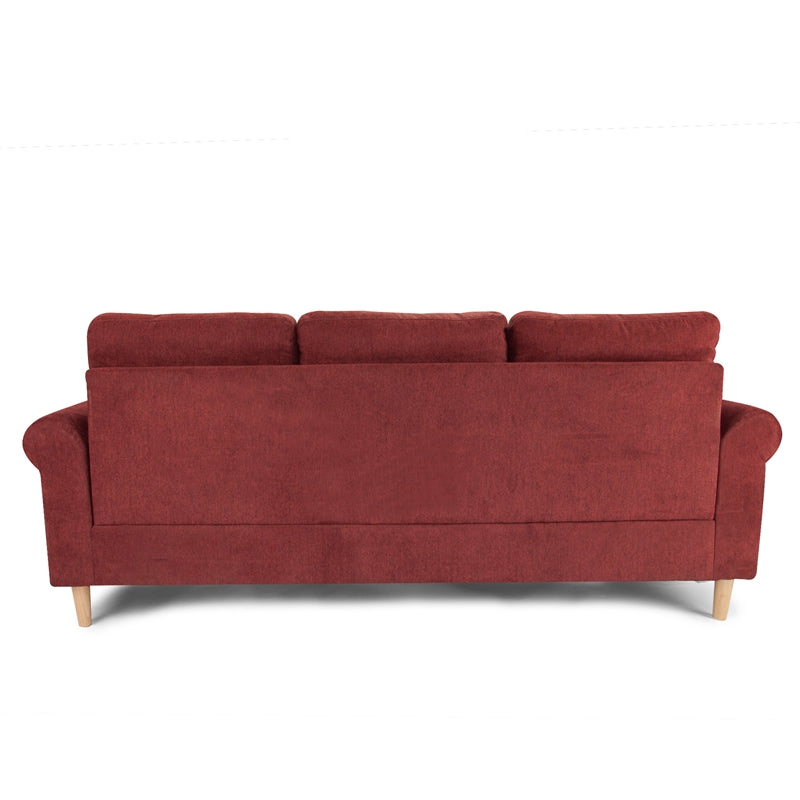 Deep red fabric sofa with three plush back cushions and short wooden legs
