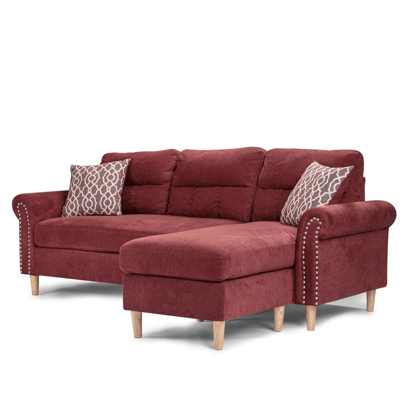 Deep red chaise sectional sofa with studded arms and decorative throw pillows