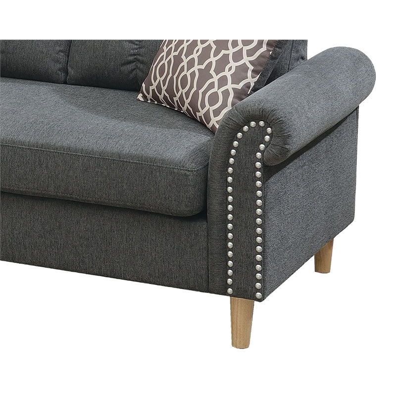 Dark grey fabric sofa with decorative nailhead trim and wooden legs