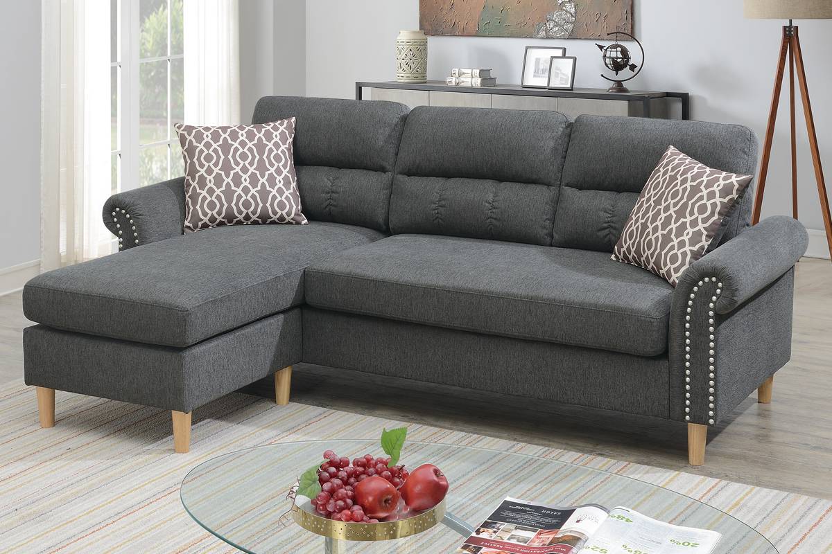 Dark grey fabric sectional sofa with chaise tufted back and decorative nailhead trim