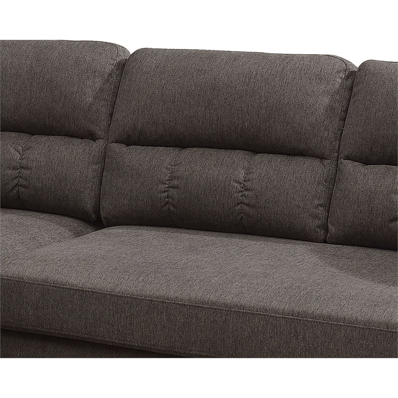 Closeup of a charcoal grey fabric sectional sofas tufted back cushions