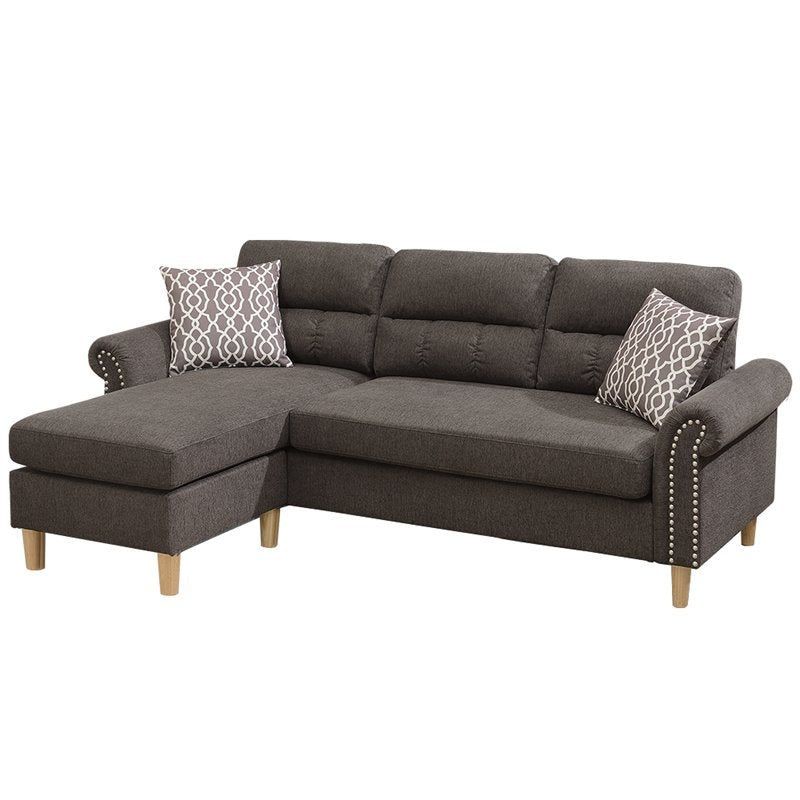 Charcoal gray sectional sofa with tufted back cushions and nailhead trim